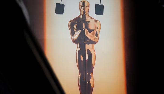 A large billboard sign featuring an Oscar statuette towers over Hollywood blvd as workers prepare for the 98th Academy Awards in Los Angeles, California, US, March 9, 2026. — Reuters