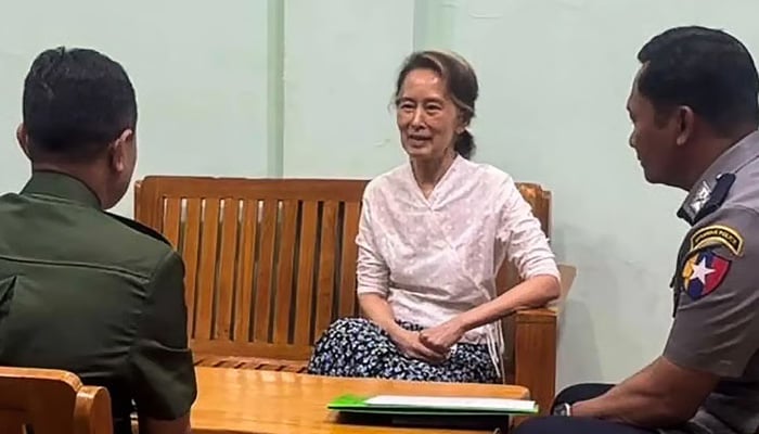 This undated handout photo from the Myanmar Military Information Team released on April 30, 2026 shows Aung San Suu Kyi (centre) talking in an undisclosed location. — AFP