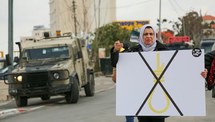 A Palestinian protester holds a placard showing a crossed-out noose during a rally in the Beit Jala village near Bethlehem, in the occupied West Bank. — AFP/File