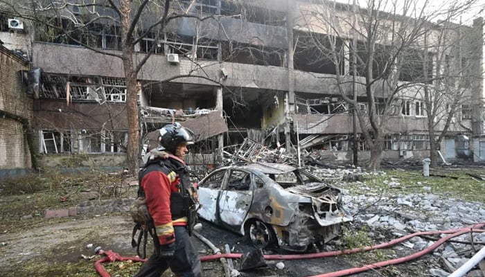 A firefighter walks past a burned-out car following a Russian drone strike in Kharkiv, Ukraine. — AFP/File