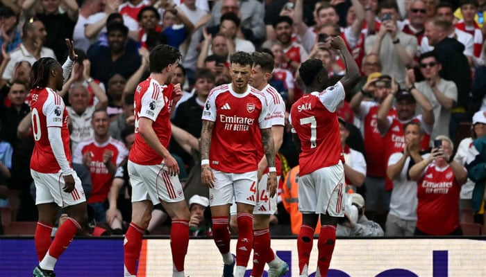 Arsenal players waving to fans. —AFP