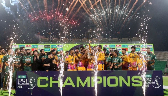 Peshawar Zalmi players and support staff celebrates with the PSL 11 trophy after beating Hyderabad Kingsmen in the final at the Gaddafi Stadium in Lahore on May 3, 2026. — PSL