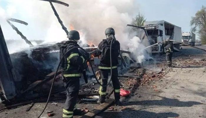 This handout photograph taken and released by the State Emergency Service of Ukraine on May 3, 2026 shows firefighters extinguishing a fire at the site of a drone attack in Dnipropetrovsk region. — AFP