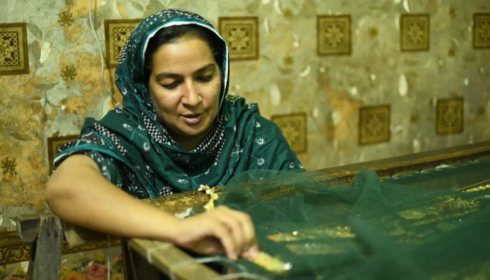 A woman doing embroidery by hand. —Kashf Foundation/File