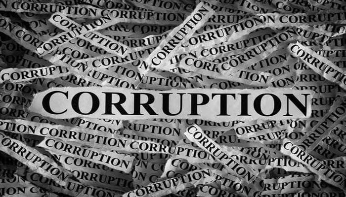 The representational image shows the word CORRUPTION printed repeatedly on numerous torn scraps of paper, piled together in a disorganised heap. — The News/File