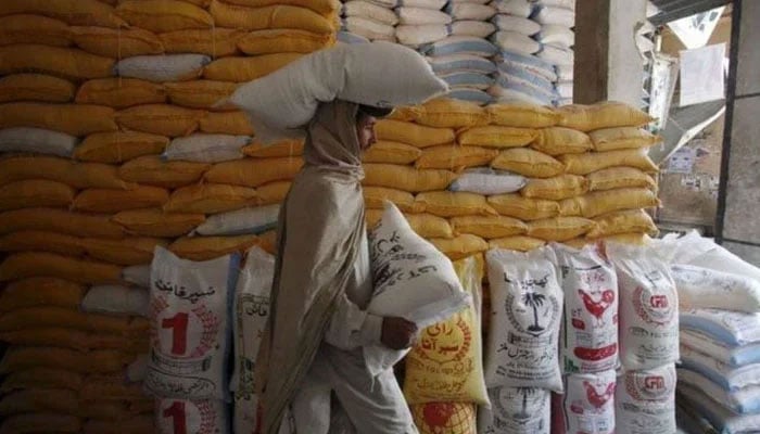 The representational image shows a labourer carrying flour bags. — Reuters/File