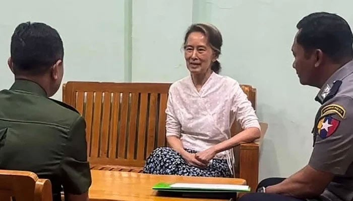 This undated handout photo from the Myanmar Military Information Team released on April 30, 2026 shows Aung San Suu Kyi (centre) talking in an undisclosed location. — AFP