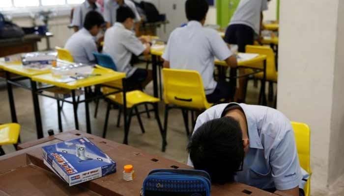 A student takes a break during a model aeroplane assembly enrichment class at a secondary school in Singapore. — Reuters/File