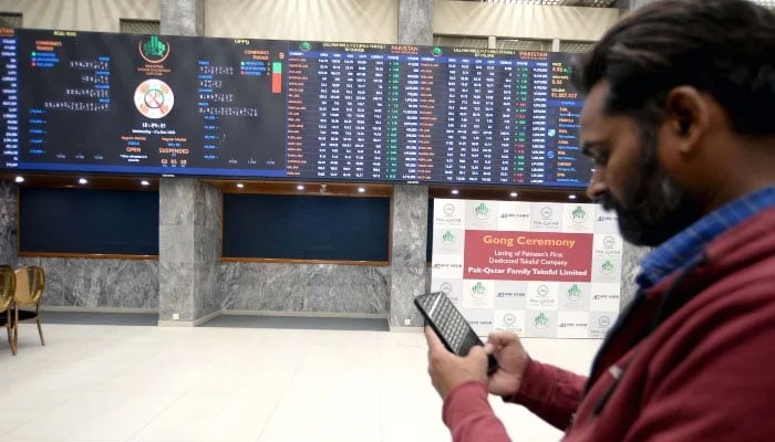 Broker is busy in trading at Pakistan Stock Exchange (PSX) in Karachi on Wednesday, December 31, 2025. — PPI