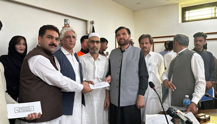 An image from the cheque distribution ceremony, the heirs of victims of the Hattar gas pipeline blast on May 6, 2026. — Facebook@BabarNawazKhanOfficial