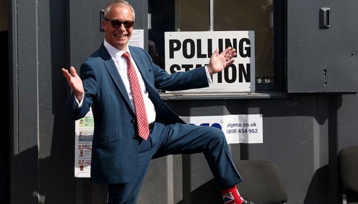 Britains Reform UK leader Nigel Farage poses outside a polling station after voting during local elections in Walton-on-the-Naze, Britain, May 7, 2026.—Reuters