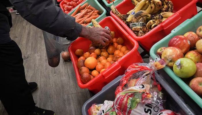 A community member grabs a piece of fruit at The Community Assistance Center food pantry, in Atlanta, Georgia, US April 12, 2023. — Reuters