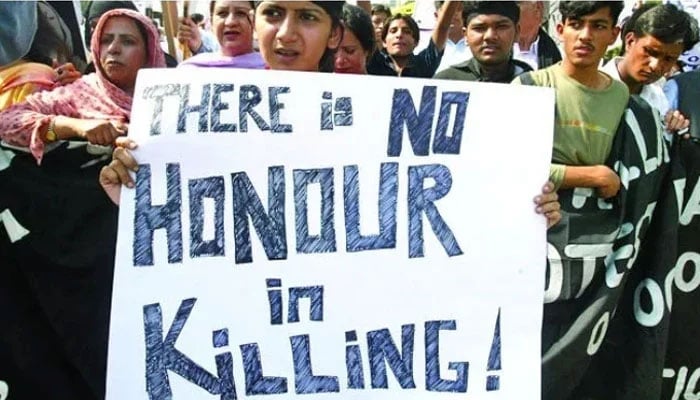 A representational image showing a woman holding a banner against honour killing at a protest in Pakistan. — Reuters/ File