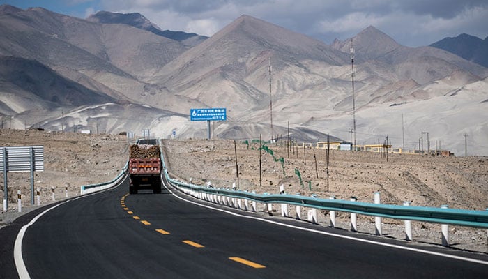 This picture taken on June 27, 2017 shows a truck driving along the China-Pakistan Friendship Highway before the Karakorum mountain range near Tashkurgan in Chinas western Xinjiang province. — AFP