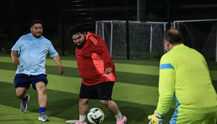Participants in the Man vs Fat Soccer weight-loss program play a soccer game, in Houston, Texas. — AFP/File