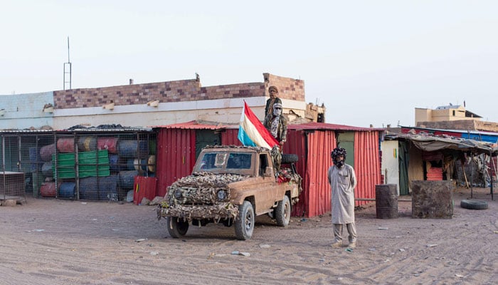 Soldiers from the National Front for the Liberation of Azawad (FLA) gather near a pick-up truck as they control a street corner in Kidal, on May 8, 2026. — AFP