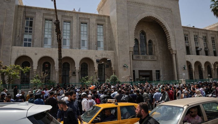 People gather outside the Palace of Justice, on the day of a trial session of Atef Najib, a brigadier general and former head of the Political Security Department in Daraa during Syrias ousted dictator Bashar Assads rule, in Damascus, Syria, April 26, 2026. — Reuters