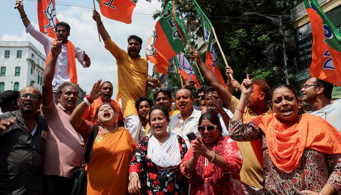 Indias ruling Bharatiya Janata Party (BJP) supporters celebrate as early trends show their party leading in the West Bengal state assembly election results, outside the partys regional office in Kolkata, India, May 4, 2026. — Reuters
