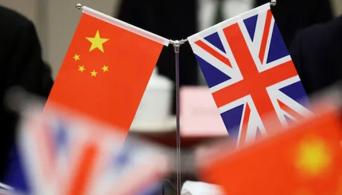 This image features desk flags representing the Peoples Republic of China and the United Kingdom. — Reuters/File