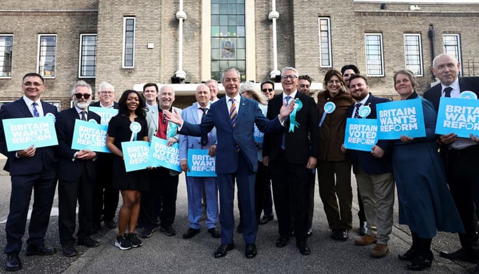 Britains Reform UK leader Nigel Farage poses with newly elected councillors and Member of Parliament, Andrew Rosindell at the Havering Town Hall, following the results of the local elections, in the London Borough of Havering, Britain, May 8, 2026. — Reuters