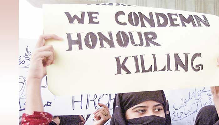 This image depicts a protest against honour killings in Pakistan, featuring a placard with the message WE CONDEMN HONOUR KILLING. — The News/File