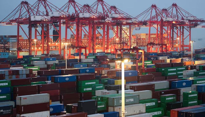 Gantry cranes stand near stacked shipping containers at Yangshan Port outside Shanghai, China, May 7, 2026.—Reuters
