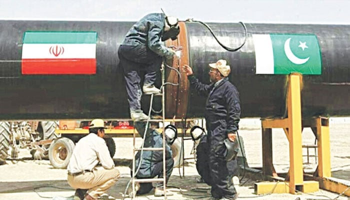 A representational image of workers busy welding pipes of the Pak-Iran gas pipeline. —AFP/File