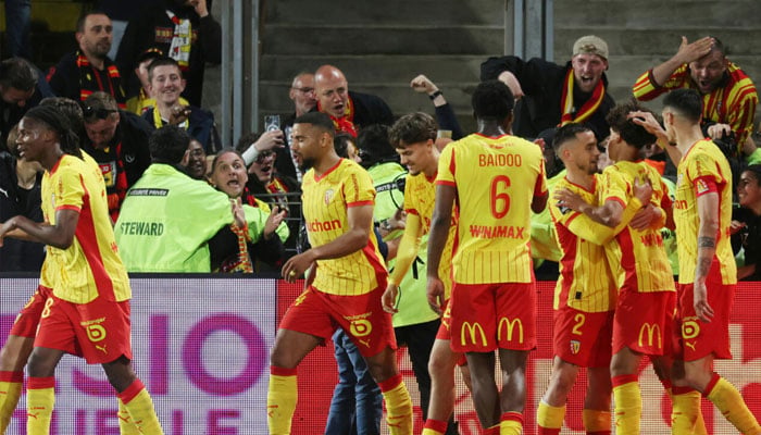 Lens celebrate after the goal from Mezian Mesloub Soares (2nd R) that secured them Champions League football next season. —AFP