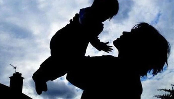 This representational image shows a silhouette of a woman lifting a baby against a cloudy sky. — Reuters/File