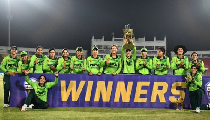 Pakistan Womens cricket team players posing for a photo with the trophy. —PCB