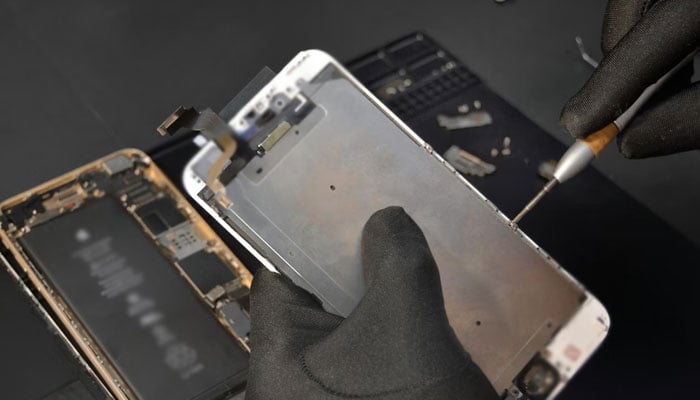 This representational image shows a technician repairing a mobile phone. — Unsplash/File