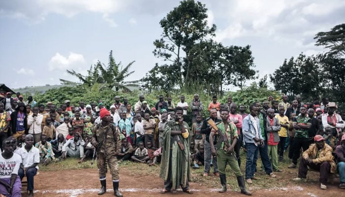 CODECO militiamen and members of the Lendu community attend a meeting with former strongmen in Wadda, Ituri province, DRC. —AFP