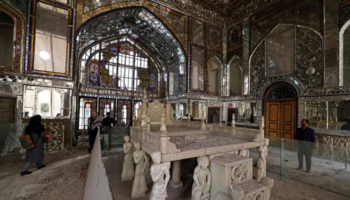 Visitors walk through the damaged interiors of the historic Golestan Palace in Tehran on April 4, 2026. — AFP