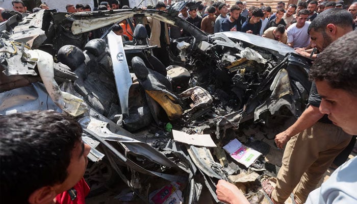 Palestinians inspect the site of an Israeli strike on a car in Khan Younis, in the southern Gaza Strip, May 10, 2026.—Reuters