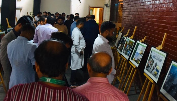 Participants viewing the pictures displayed on the Marka-e-Haq celebration in the Pakistan embassy in BD. —Facebook@PakinBangladesh