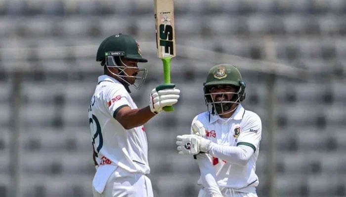 Bangladeshs captain Najmul Hossain Shanto (left) reacts after scoring a half-century as his teammate Mominul Haque watches during the first test match against Pakistan at the Sher-e-Bangla National Stadium in Mirpur on May 8, 2026. — AFP