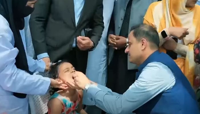 Karachi Mayor Murtaza Wahab administers anti-polio drops to a child to inaugurate the Polio Booster Dose Campaign at Lyari International Football Stadium on May 11, 2026. — Screengrab via Facebook@barristermurtazawahabofficial