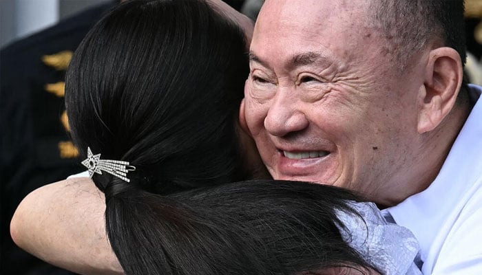 Thaksin Shinawatra hugs his daughter Paetongtarn at Klong Prem Central Prison in Bangkok. — AFP