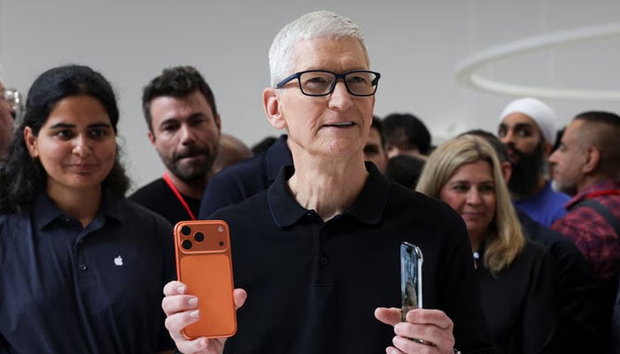 Apple CEO Tim Cook holds an iPhone 17 pro and an iPhone Air, as Apple holds an event at the Steve Jobs Theater on its campus in Cupertino, California, US September 9, 2025.—Reuters