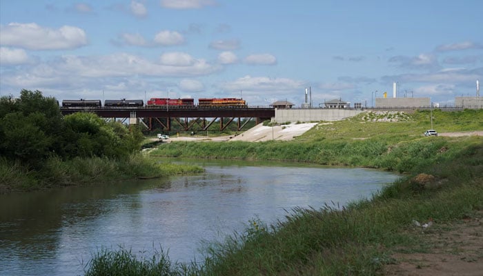 A freight train coming from Mexico crosses the border after six bodies were found on Sunday in a train boxcar, in Laredo, Texas, US, May 11, 2026.—Reuters