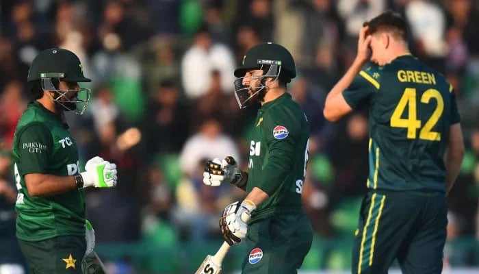 Pakistan batters Salman Ali Agha (centre) and Babar Azam (left) exchanging fist bump during the first T20I match against Australia at Gaddafi Stadium on January 29, 2026 in Lahore. — AFP