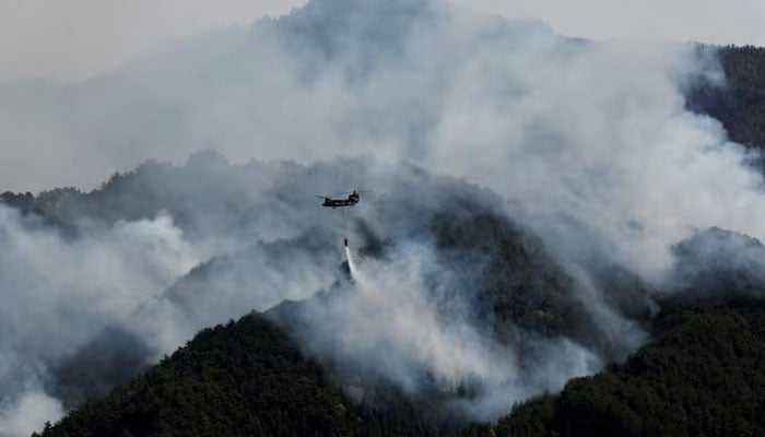 A helicopter conducts firefighting operations as wildfires continue in Otsuchi, Iwate Prefecture, Japan, April 26, 2026. —Reuters