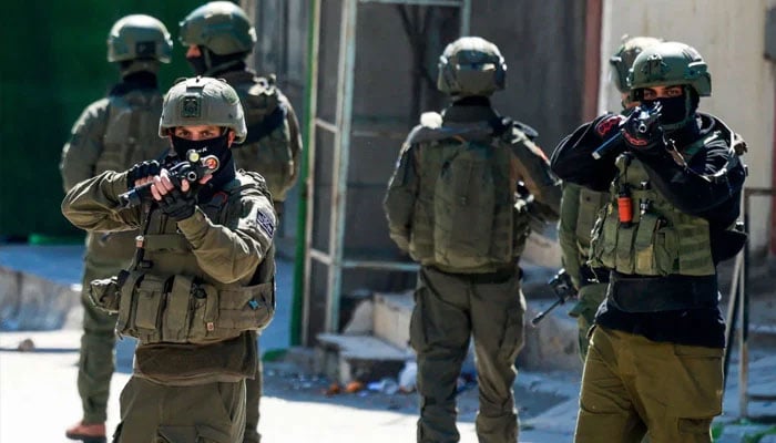 Israeli soldiers patrol a street during a military operation in the Askar refugee camp in eastern Nablus, Israeli-occupied West Bank, on March 2, 2026. —AFP