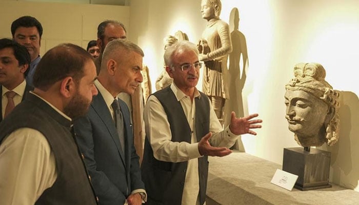 Pakistans Minister for National Heritage and Culture Aurangzeb Khan Khichi (left) and US Assistant Secretary Paul Kapur (second-left) looking at a stolen artifact recently returned to Pakistan on display in Islamabad, Pakistan, on May 13, 2026. —US Embassy in Pakistan.