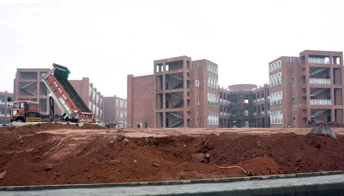 Labourers are seen at the construction site of the Daanish School at Kuri Road in the Federal Capital on January 1, 2026. — Online