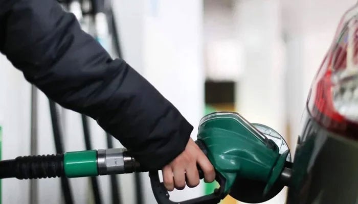 A person fills their cars tank at a fuel station in this undated image. — AFP/File