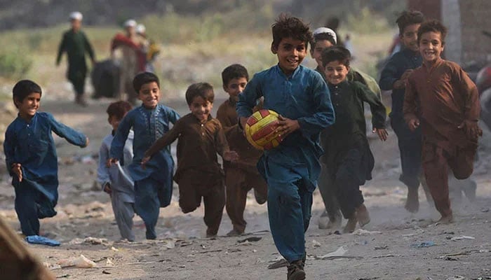 Children play in Afghan Basti area on the outskirts of Lahore on the eve of World Refugee Day. — AFP/File