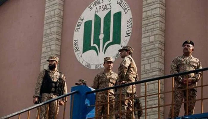 The security forces personnel standing in the Army Public School, Peshawar after the massacre. — The News/File