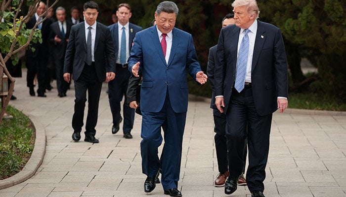 President Donald Trump walks with Chinese President Xi Jinping while leaving after a visit to the Zhongnanhai Garden in Beijing, China, May 15, 2026. — Reuters
