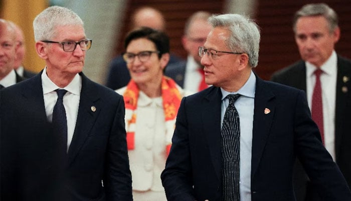 Nvidia CEO Jensen Huang and Apple CEO Tim Cook arrive for the meeting between Chinese Premier Li Qiang and US business representatives, at the Great Hall of the People in Beijing, China, May 14, 2026.—Reuters